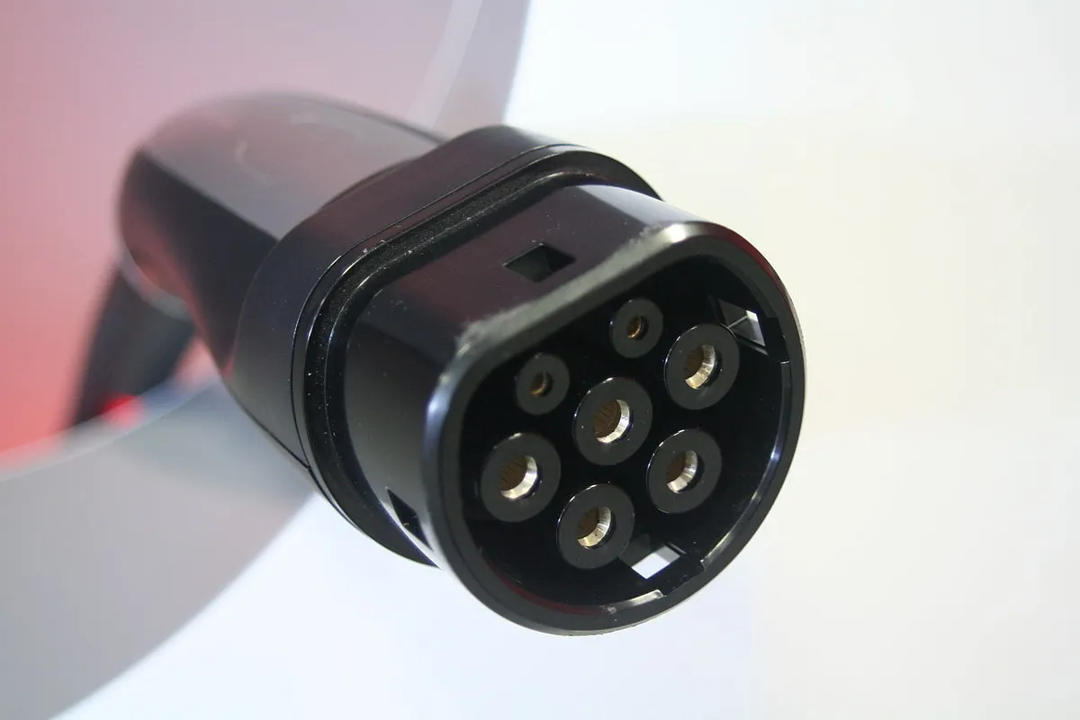 European Tesla Supercharger station showing a modified Type 2 connector charge outlet, photographed in Frankfurt