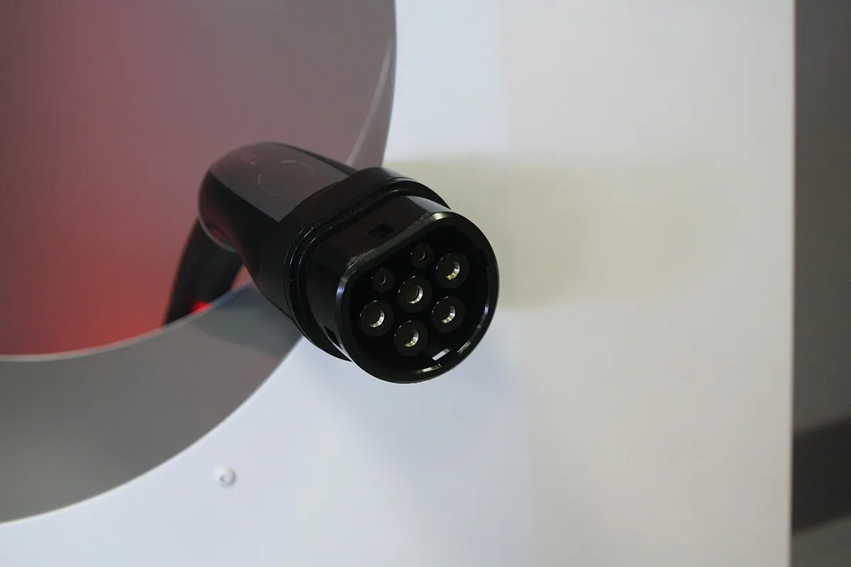 European Tesla Supercharger station showing a modified Type 2 connector charge outlet, photographed in Frankfurt